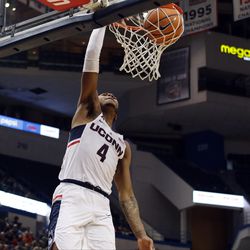 UConn's Jalen Adams (4) slams it home. during the Monmouth Hawks vs UConn Huskies men's college basketball game at the XL Center in Hartford, CT on December 2, 2017.
