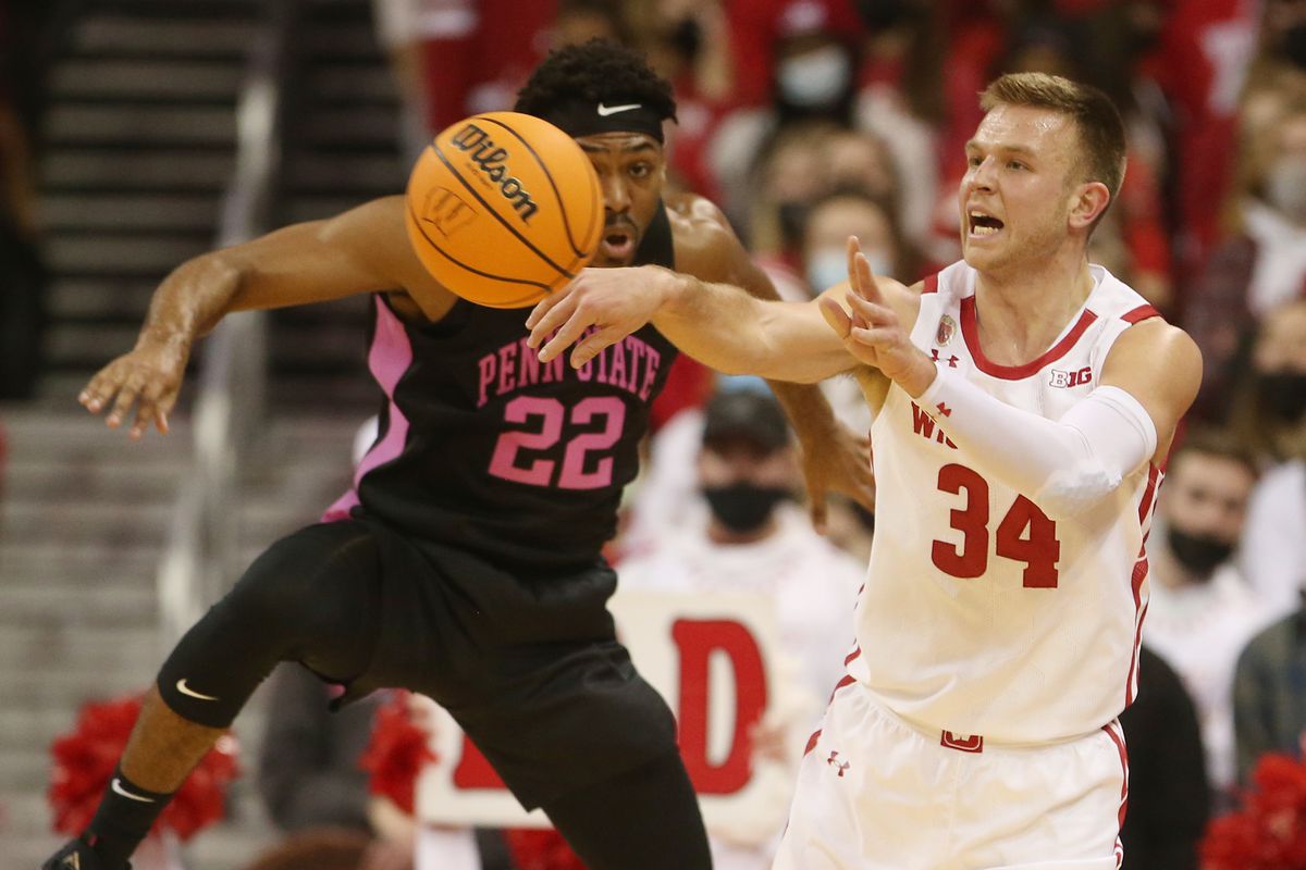 Wisconsin Badgers guard Brad Davison (34) passes the ball as Penn State Nittany Lions guard Jalen Pickett (22) defends during the first half at the Kohl Center