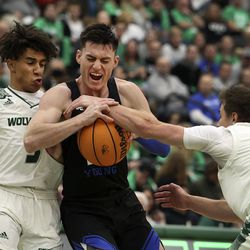 Brigham Young Cougars guard Alex Barcello (13) is stopped by Utah Valley Wolverines guard Blaze Nield (3) and Utah Valley Wolverines guard Connor Harding (15) at Utah Valley University in Orem on Wednesday, Dec. 1, 2021.
