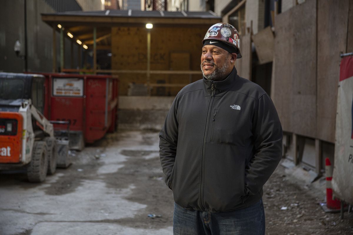 Herman Pride, owner of Complete Mechanical Piping, outside a job site at 226 W. Jackson Blvd., where an office building is being converted into two Hilton-branded hotels.