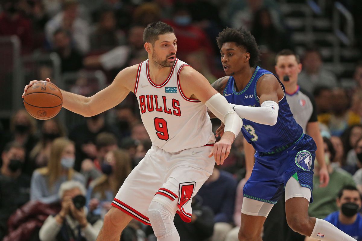 Chicago Bulls center Nikola Vucevic (9) dribbles the ball while defended by Minnesota Timberwolves forward Jaden McDaniels (3) during the second half at the United Center.