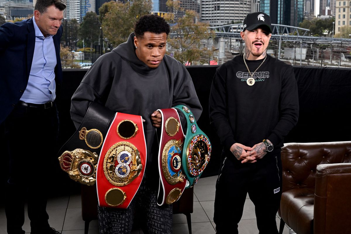 Devin Haney of the US (C) holds his title belts after a face-off with Australia’s George Kambosos (R) in Melbourne on October 11, 2022, ahead of their rematch for the lightweight unification title to become the undisputed lightweight boxing champion of the world.