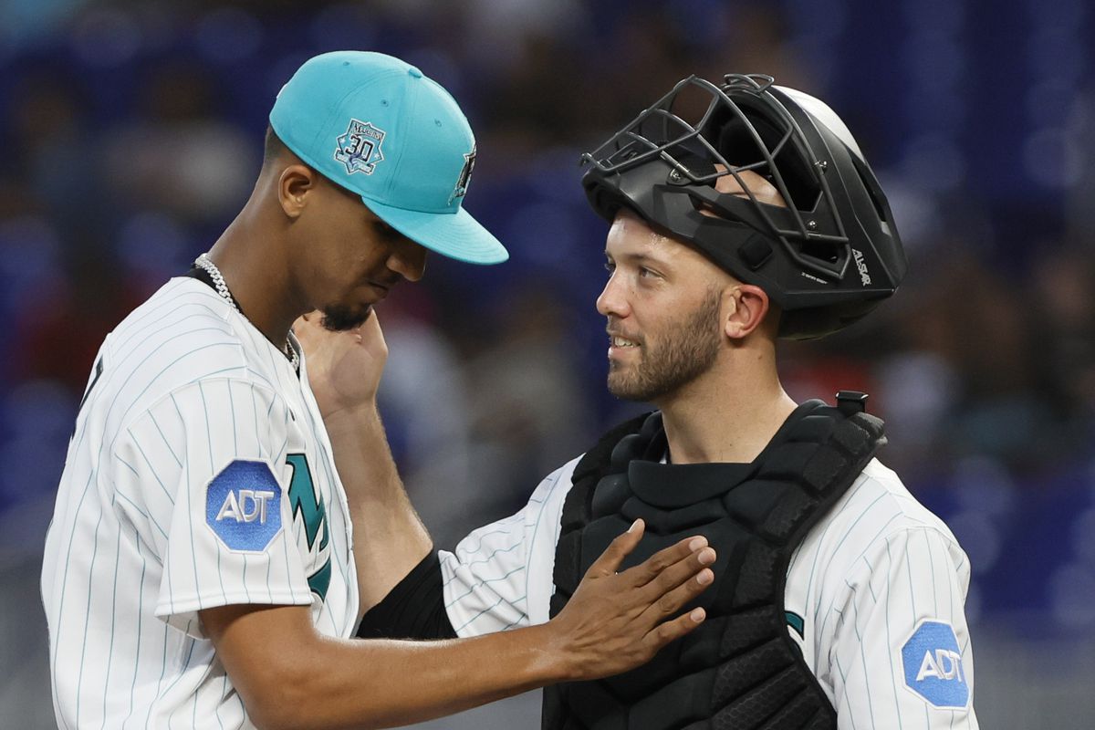 Miami Marlins starting pitcher Eury Perez (39) celebrates with catcher Jacob Stallings (58) as he leaves the game against the Cincinnati Reds during the fifth inning at loanDepot Park.