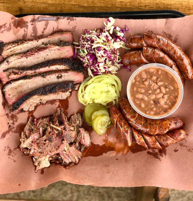 Barbecue and sides on butcher paper.