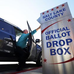Jeff Dart places his ballot in a drop box at the Salt Lake County Government Center in Salt Lake City on Monday, Nov. 7, 2016.