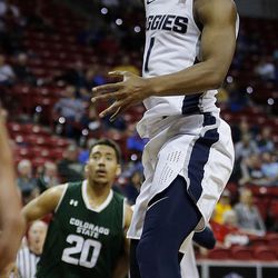 Utah State Aggies guard Koby McEwen takes a shot with Colorado State Rams forward Deion James in the background defending during the Mountain West Conference basketball tournament in Las Vegas on Wednesday, March 7, 2018.