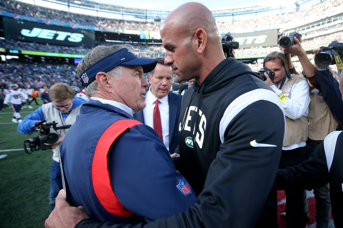 New England Patriots head coach Bill Belichick meets New York Jets head coach Robert Saleh at midfield after a game at MetLife Stadium.