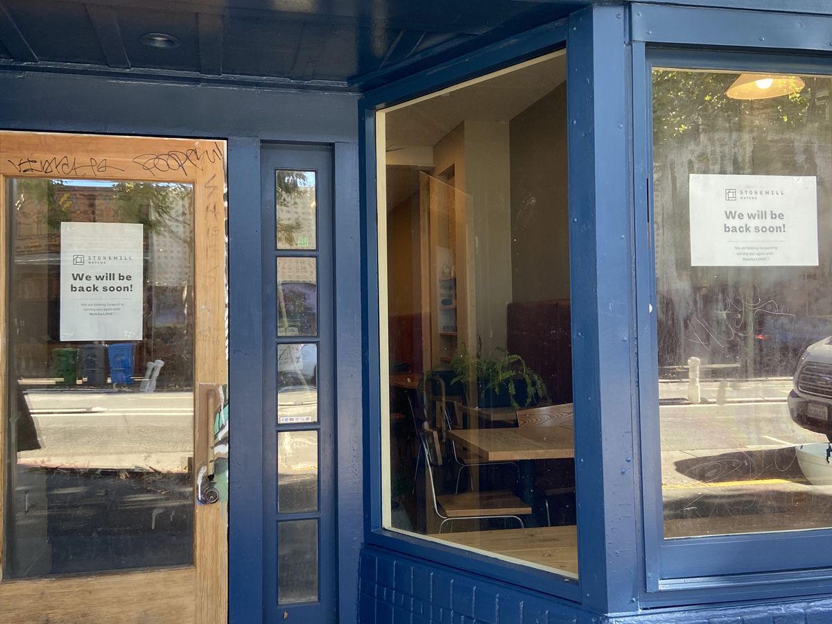 The exterior of Stonemill Matcha in San Francisco with signs on the window proclaiming the business “will be back soon!”