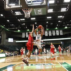 Utah Valley guard Ben Nakwaasah prepares to shoot over Eastern Washington's Sir Washington during the first round of the College Basketball Invitational at UCCU Center in Orem on Tuesday, March 13, 2018.