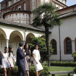 U.S. first lady Michelle Obama talks with Italian premier Matteo Renzi as she arrives at the Santa Maria delle Grazie church to see Leonardo's masterpiece "The Last Supper", after partecipating in a cooking demonstration at the James Beard American Restaurant with Italian and American middle school students in Milan, Italy, Wednesday, June 17, 2015. Behind them are her daughters Malia and Sasha. Michelle Obama is in Milan on the second leg of a European trip that puts an international spin on her core initiatives. 