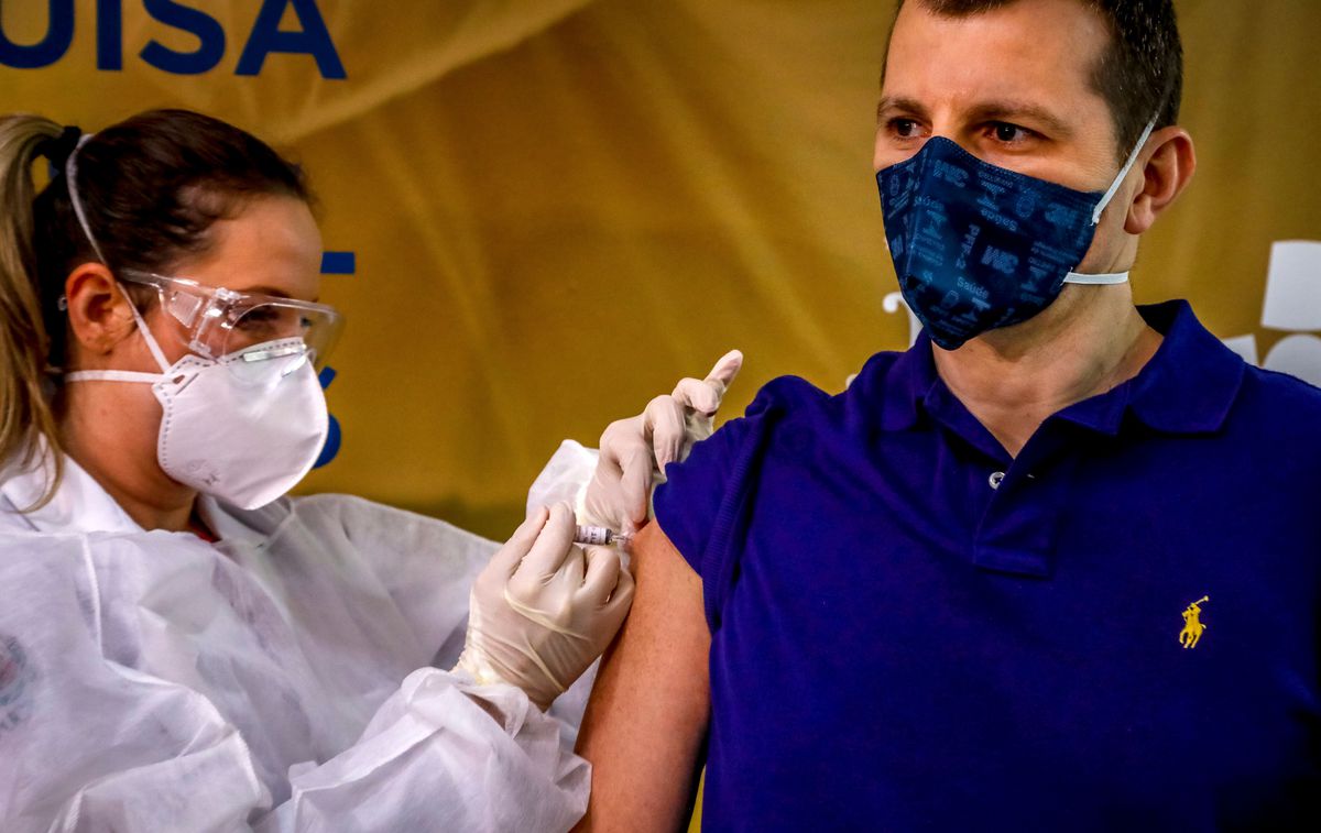 Health worker and volunteer Luciano Marini receives a COVID-19 vaccine produced by Chinese company Sinovac Biotech at the Sao Lucas Hospital, in Porto Alegre, southern Brazil on August 08, 2020.