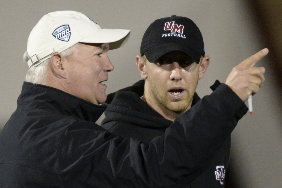 (Amherst, MA, 04/03/14) Mark Whipple, left, who returns for his second stint as the head coach of the Massachusetts Minutemen football team, talks with his former quarterback and now quarterback coach Liam Coen during spring practice at the UMass-Amh