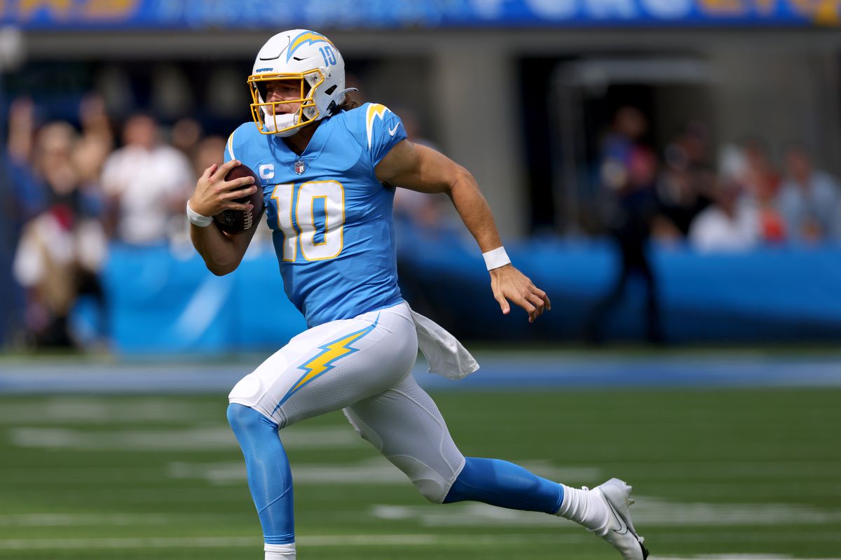 Justin Herbert #10 of the Los Angeles Chargers runs with the ball during a 47-42 win over the Cleveland Browns at SoFi Stadium on October 10, 2021 in Inglewood, California.