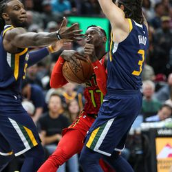 Utah Jazz forward Jae Crowder (99) and guard Ricky Rubio (3) put the defense on Atlanta Hawks guard Dennis Schroder (17) during the game at Vivint Smart Home Arena in Salt Lake City on Tuesday, March 20, 2018.