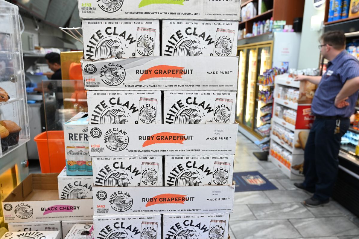 A stack of cases of White Claw inside a convenience store