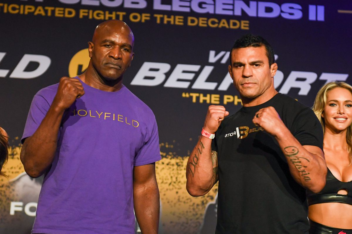 Evander Holyfield and Vitor Belfort pose for the press at a media event for their PPV boxing match.