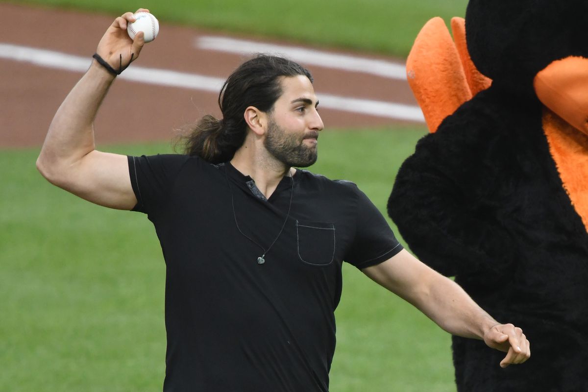 Bryan Ruby, an openly gay baseball player and country music performer, throws out the first pitch on Pride Night at Oriole Park at Camden Yards on June 22, 2022 in Baltimore.
