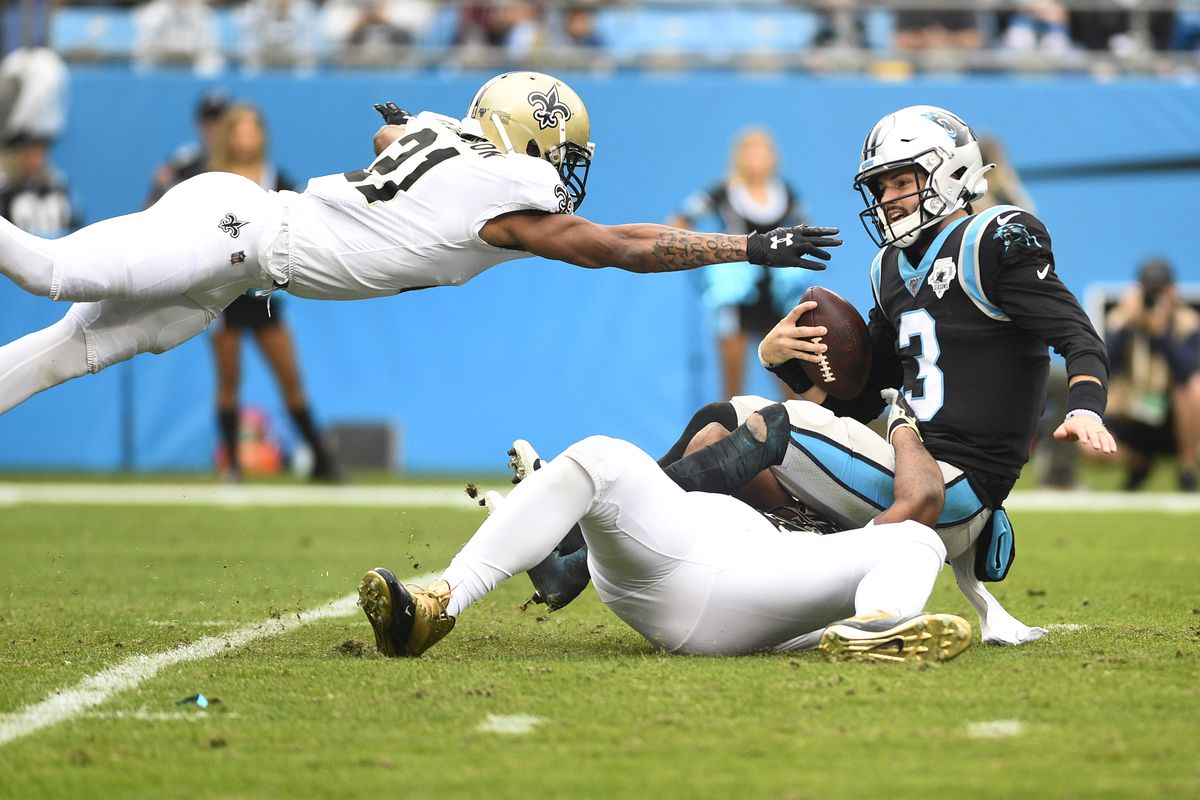 Carolina Panthers quarterback Will Grier is sacked by New Orleans Saints defensive end Cameron Jordan and defensive back Patrick Robinson in the second quarter at Bank of America Stadium.