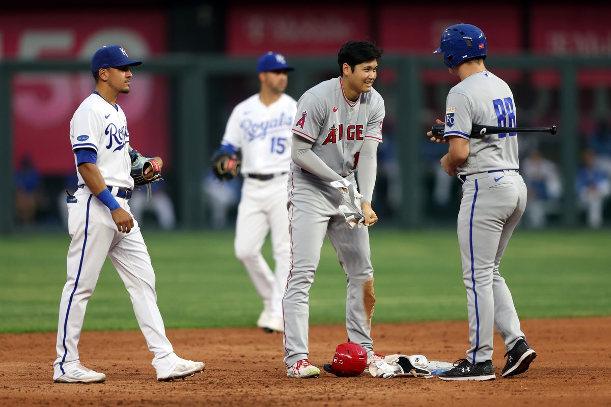 Shohei Ohtani #17 of Japan of the Los Angeles Angels is checked on by the bat boy at second base after taking a ball off the knee then hitting a double during the 3rd inning of the game against the Kansas City Royals at Kauffman Stadium on July 25, 2022 in Kansas City, Missouri.