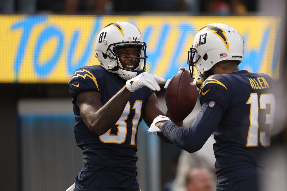 Mike Williams #81 of the Los Angeles Chargers celebrates his touchdown with Keenan Allen #13 during the second quarter of the game against the Seattle Seahawks at SoFi Stadium on October 23, 2022 in Inglewood, California.