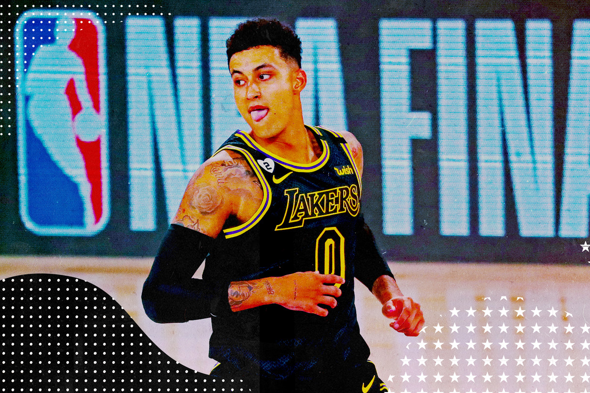 Kyle Kuzma is playing for the Lakers in the NBA Bubble at Disney World, wearing the black Kobe Bryant inspired jerseys. In this photo, he’s running down the court, slightly sticking out his tongue.