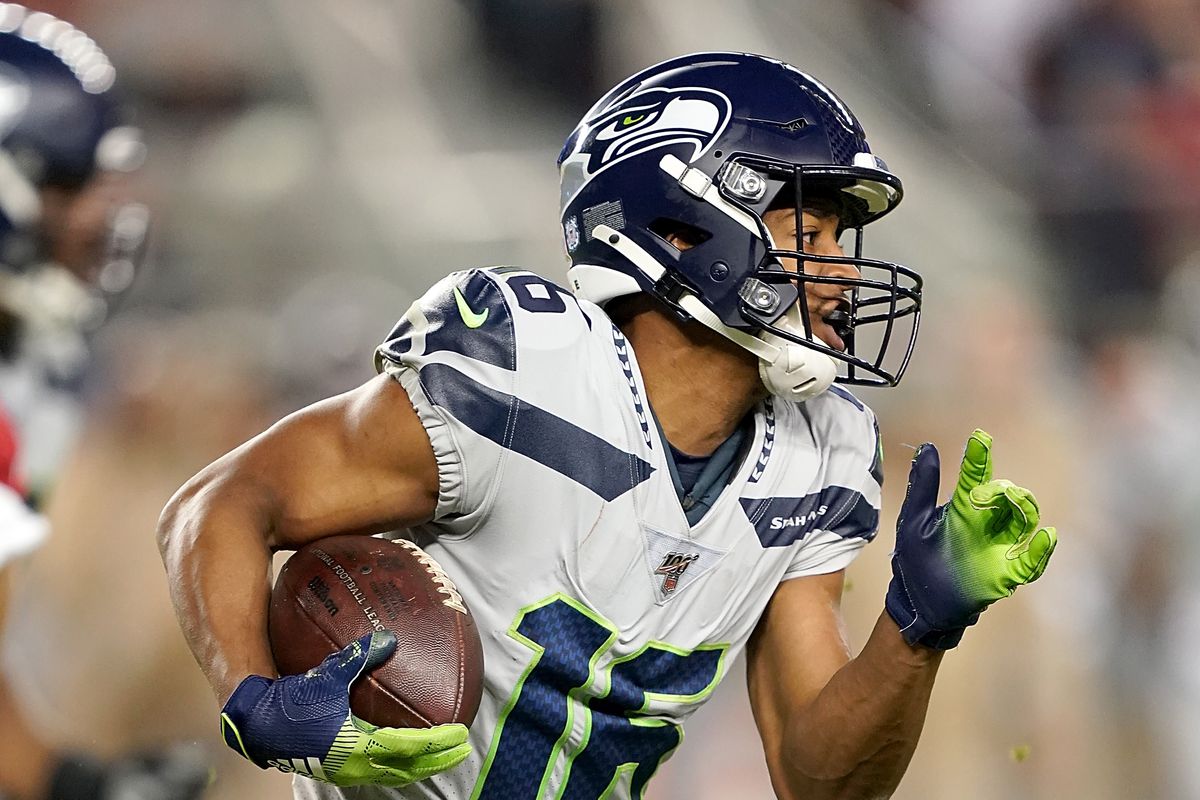 Wide receiver Tyler Lockett of the Seattle Seahawks carries the ball against the defense of the San Francisco 49ers in the game at Levi’s Stadium on November 11, 2019 in Santa Clara, California.