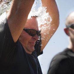 Draper Police Sgt. Scott Adams dumps a bucket of water on himself during the the Utah Law Enforcement Memorial Ice Water Challenge at Draper Historic Park, Wednesday, Sept. 3, 2014. One bucket of ice water was dumped on an officer's head for each of the 137 officers who have been killed in the line of duty in Utah.