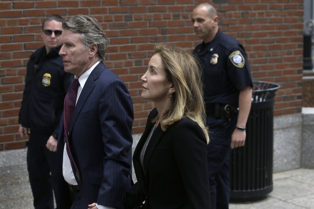 Actress Felicity Huffman arrives with her brother Moore Huffman Jr., at federal court Monday, May 13, 2019, in Boston, where she is scheduled to plead guilty to charges in a nationwide college admissions bribery scandal. 