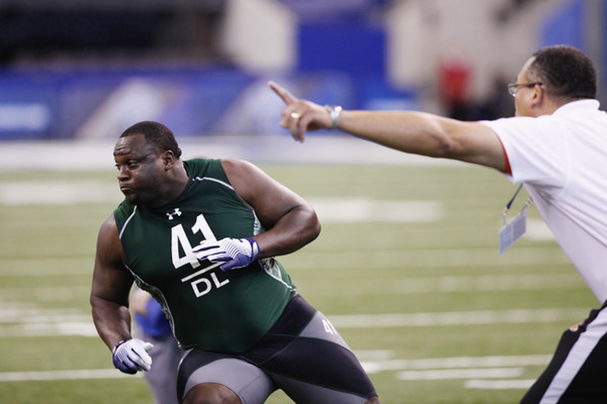 INDIANAPOLIS, IN - FEBRUARY 28: Defensive lineman Jerrell Powe of Ole Miss runs through a drill during the 2011 NFL Scouting Combine.