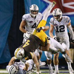 Wyoming Cowboys wide receiver Tanner Gentry (4) is upended by the Brigham Young Cougars defense during the Poinsettia Bowl in San Diego on Wednesday, Dec. 21, 2016. BYU won 24-21.