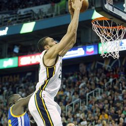 Utah Jazz center Rudy Gobert reaches for a slam dunk in the first half of an NBA regular season game against the Golden State Warriors at the Vivint Arena in Salt Lake City, Wednesday, March 30, 2016.
