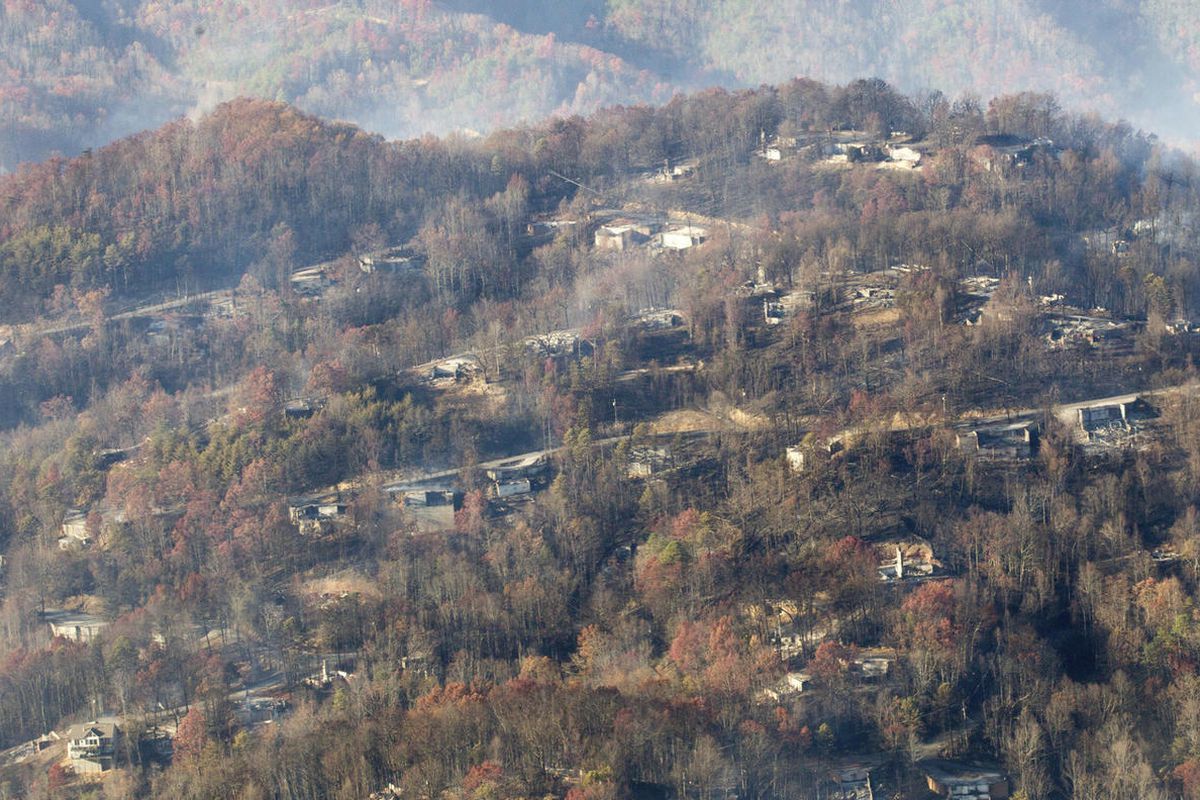 Burned structures are seen from aboard a National Guard helicopter near Gatlinburg, Tenn., Tuesday, Nov. 29, 2016. The fires spread quickly on Monday night, when winds topping 87 mph whipped up the flames, catching residents and tourists in the Gatlinburg