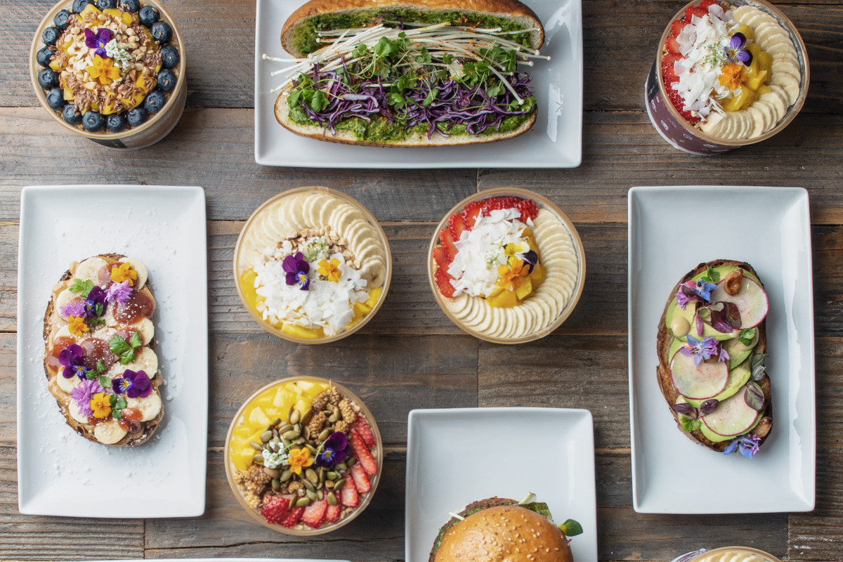A top-down view of colorful acai bowls, sandwiches, and burgers from Plantiful in Kirkland, Washington