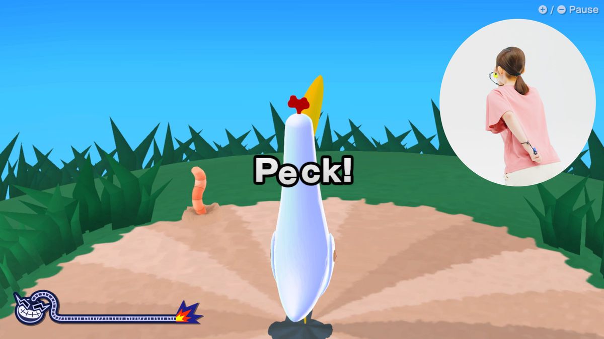 A screenshot of WarioWare: Move It! featuring a bird in the center of the screen, the prompt “Peck!” and an earthworm poking out from the ground