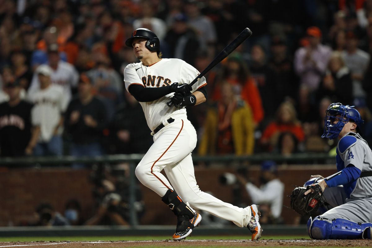 Wilmer Flores #41 of the San Francisco Giants hits a single in the second inning during Game 5 of the NLDS between the Los Angeles Dodgers and the San Francisco Giants at Oracle Park on Thursday, October 14, 2021 in San Francisco, California.