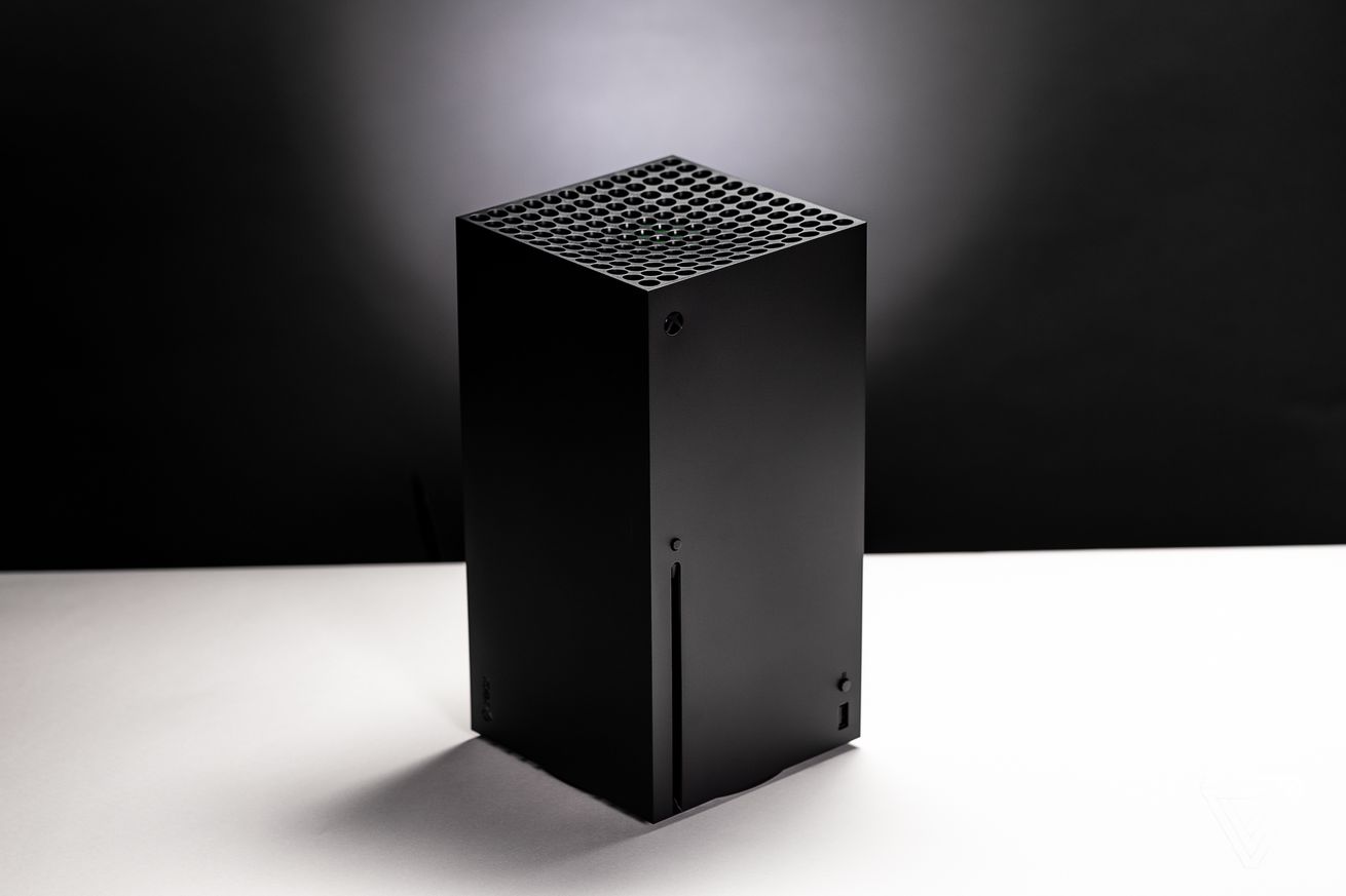 An Xbox Series X console is placed on a white surface with a black background behind it.