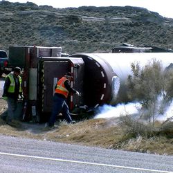 Refrigerated liquid nitrogen vents from a tanker truck that rolled Monday when the driver tried to turn from U.S. 40 onto Red Wash Road, about 10 miles west of the Utah-Colorado border in Uintah County. Two men in the truck suffered minor injuries, according to the Utah Highway Patrol.