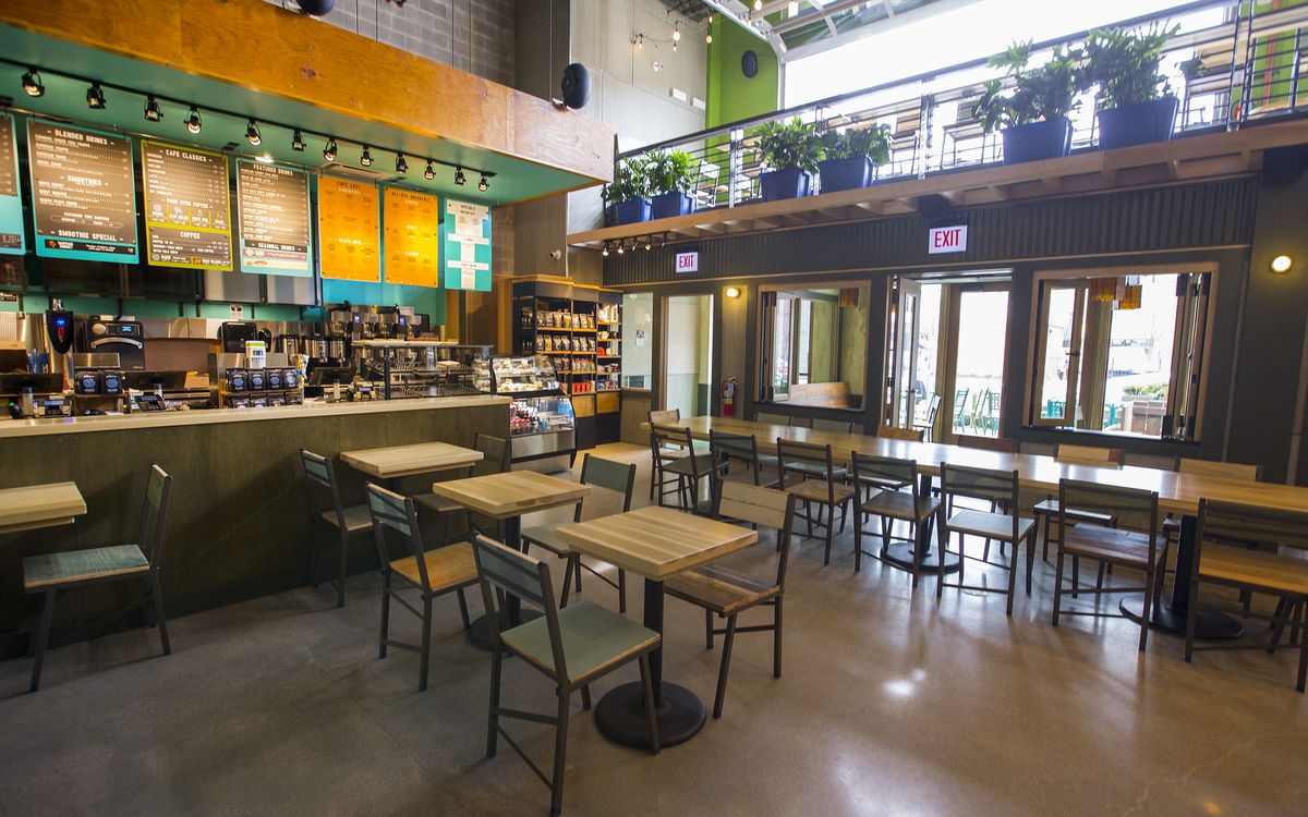 A large, two-floor cafe space with lots of tables and chairs