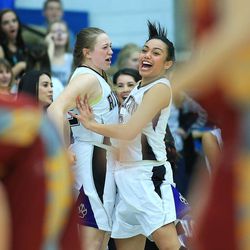 Riverton's Olivia Neilson and teammate Tiena Afu celebrate with teamates as they defeat Viewmont, 52-46, Wednesday, Feb. 18, 2015, in 5A State quarterfinal action at Salt Lake Community College in Taylorsville.