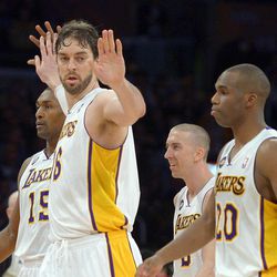Los Angeles Lakers forward Pau Gasol, second from left, of Spain, is congratulated by forward Metta World Peace, left, as guard Steve Blake, second from right, and guard Jodie Meeks looks on during the second half of their NBA basketball game, Sunday, April 14, 2013, in Los Angeles. The Lakers won 91-86. 