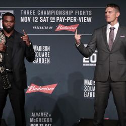 Tyron Woodley, left, holds his title belt as he poses for photographers with his opponent Stephen Thompson, right, during a news conference ahead of the UFC 205 mixed martial arts fights, Thursday, Nov. 10, 2016, at Madison Square Garden in New York. Woodley and Thompson will fight on Saturday. 