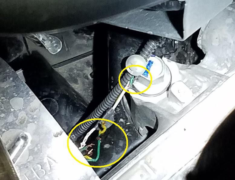 An example of rodent damage to a vehicle. The photo shows the inside of a vehicle engine; two areas with chewed wires are circled.