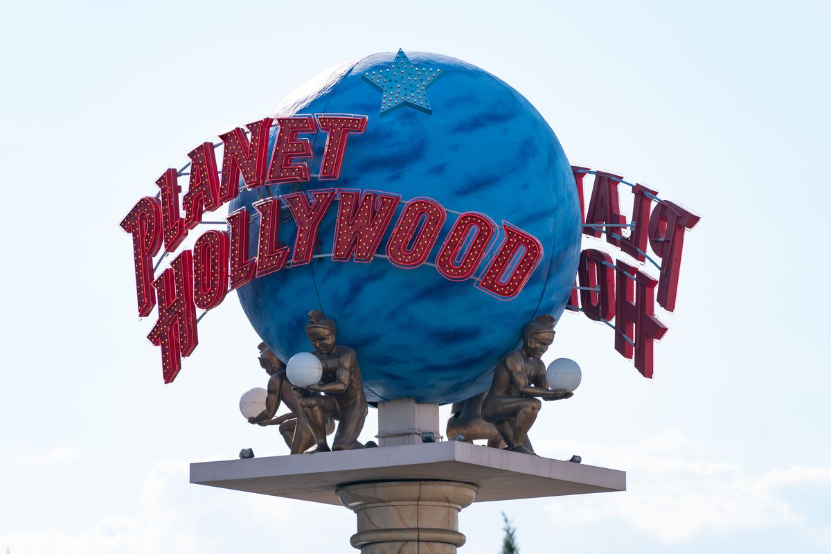 A blue globe with Planet Hollywood emblazoned in red letters around the sphere.