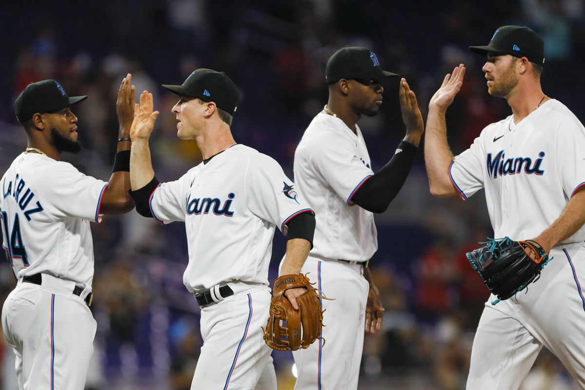 Miami Marlins third baseman Joey Wendle (center) celebrates with teammates after winning the game against the Seattle Mariners at loanDepot Park.