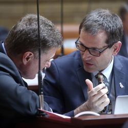 Rep. Jim Dunnigan, R-Taylorsville, and Rep. Ray Ward, R-Bountiful, discuss Proposition 3 in the House chamber during the morning legislative session at the Capitol in Salt Lake City on Tuesday, Feb. 5, 2019.