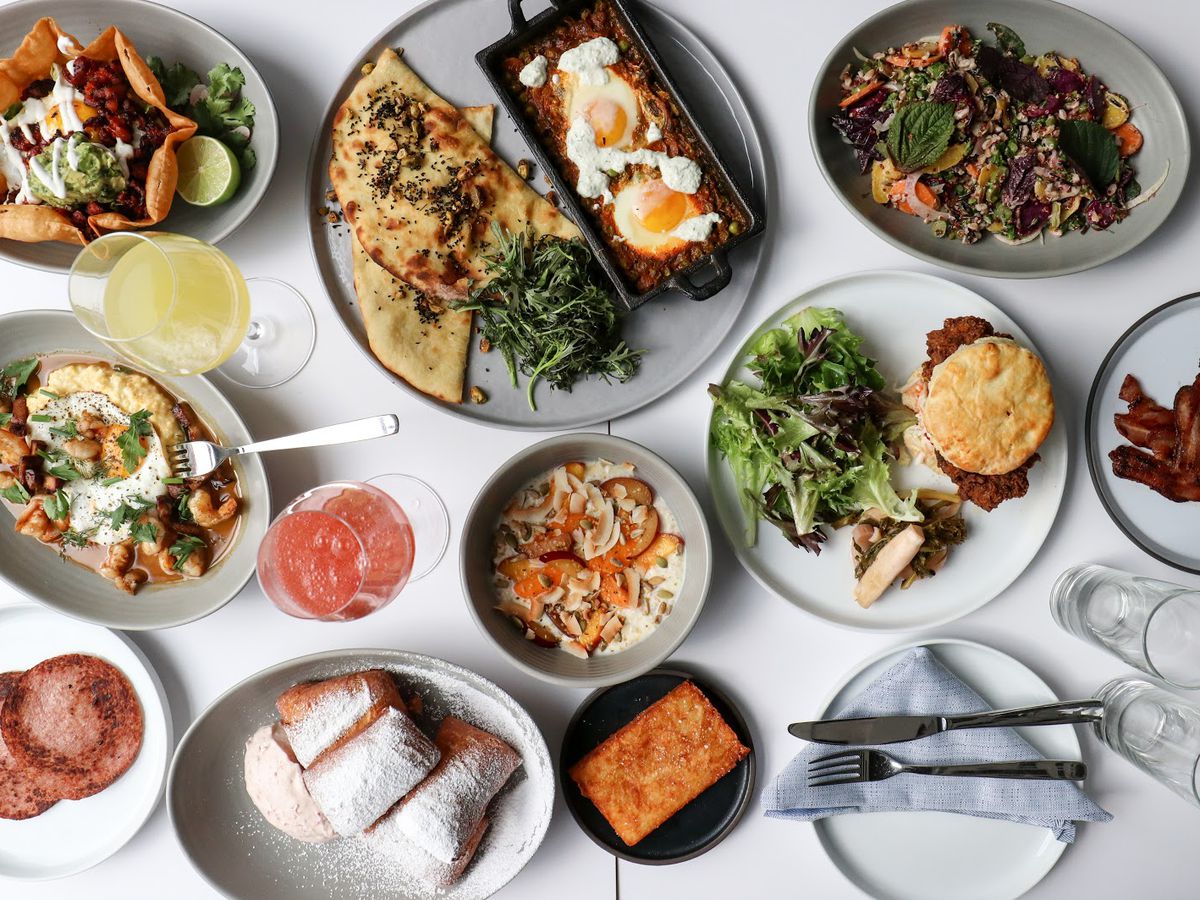 An overhead photograph of multiple dishes on a white table at a restaurant in Long Island City, called Bellwether.