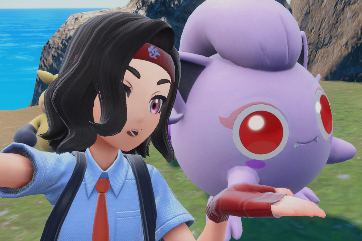 A Pokémon trainer taking a selfie and presenting a shiny Scream Tail, a Pokémon that looks like Jigglypuff but ancient.