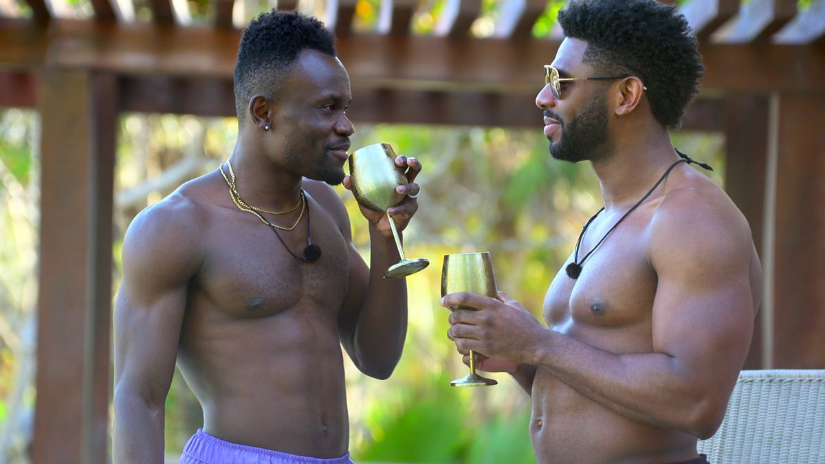 Kwame and Brett standing at the pool party drinking and talking