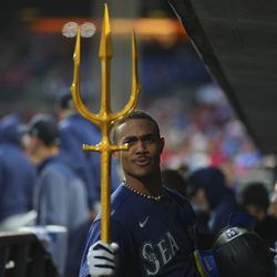 Julio Rodriguez #44 of the Seattle Mariners reacts with the trident in the dugout after hitting a solo home run in the top of the second inning against the Philadelphia Phillies at Citizens Bank Park on April 26, 2023 in Philadelphia, Pennsylvania.
