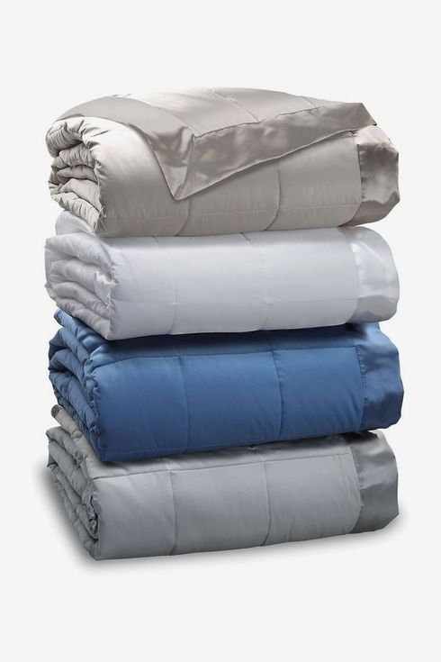 Stack of folded blankets in various colors.